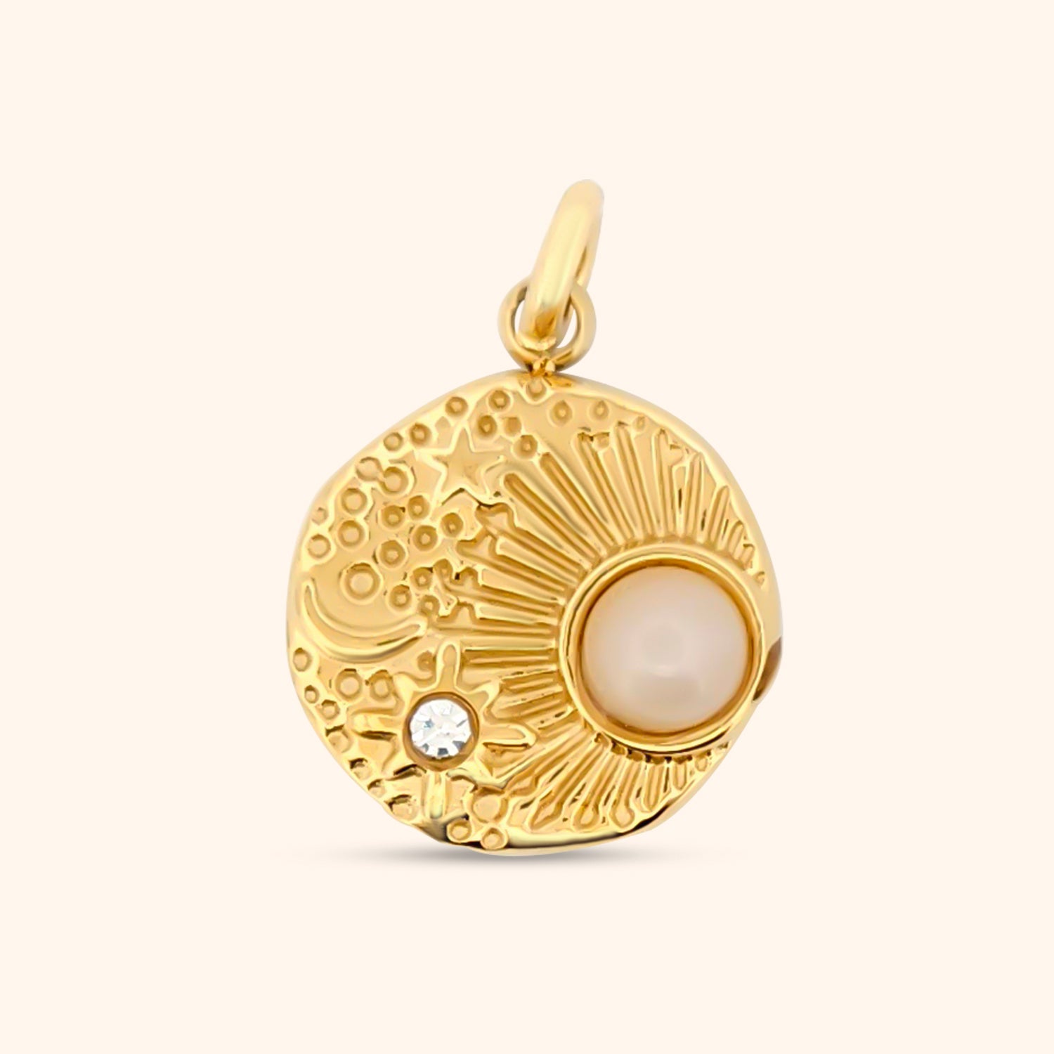 Close-up of the Celestial Charm, a circular gold charm with textured detailing and a celestial design.